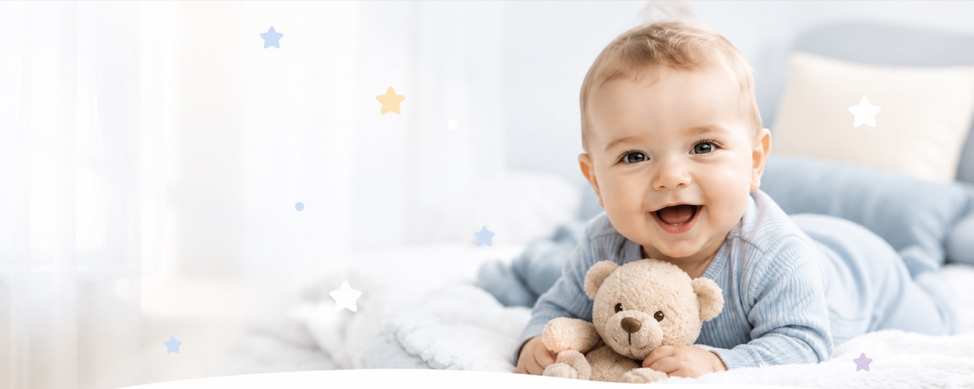 Smiling baby in a blue onesie holding a teddy bear on a soft bed surrounded by pastel star and footprint decorations